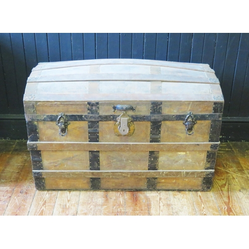 1414 - A metal bound dome topped steamer trunk, with leather carrying handles to the sides, 92cm wide.