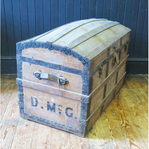 1414 - A metal bound dome topped steamer trunk, with leather carrying handles to the sides, 92cm wide.