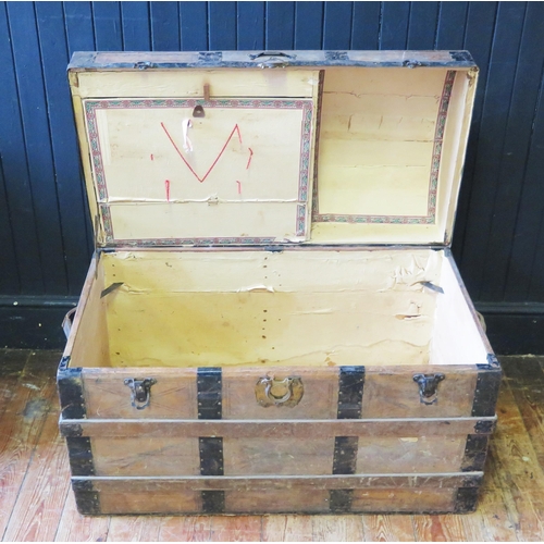 1414 - A metal bound dome topped steamer trunk, with leather carrying handles to the sides, 92cm wide.