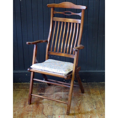 1422 - A stained beech folding elbow chair, with arched top rail and slat back, having a gross point wool w... 