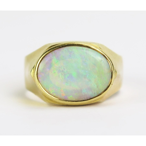 100 - An 18ct Gold and Opal Ring, c, 14x10.5mm stone, stamped 18K, size Q, 6.2g gross