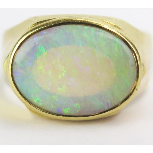 100 - An 18ct Gold and Opal Ring, c, 14x10.5mm stone, stamped 18K, size Q, 6.2g gross