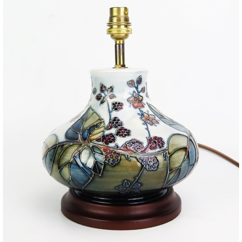 1001 - A Moorcroft pottery table lamp, in the Bramble pattern, of squat globular form, with tube-line decor... 