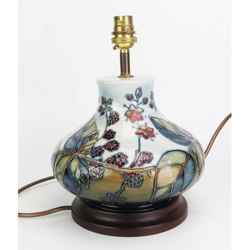 1001 - A Moorcroft pottery table lamp, in the Bramble pattern, of squat globular form, with tube-line decor... 