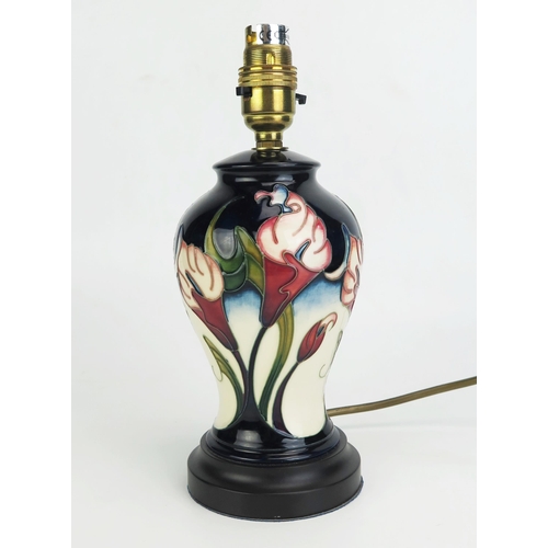 1002 - A Moorcroft pottery table lamp base, in the Calla Lily pattern, of baluster, on a stepped circular b... 