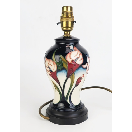 1002 - A Moorcroft pottery table lamp base, in the Calla Lily pattern, of baluster, on a stepped circular b... 