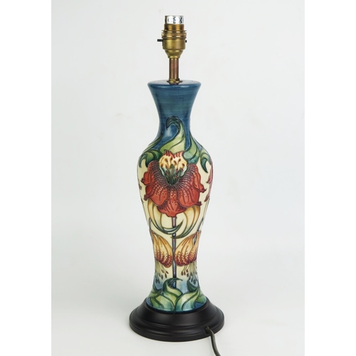 1005 - A Moorcroft pottery table lamp, of baluster form with Anna Lilly pattern decoration, mounted on a po... 