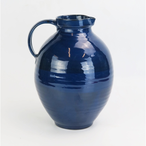 1008 - A Brannan ware pottery water jug, with dark blue glaze, impressed mark to the base, 28cm high.