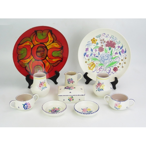 1009 - A collection of assorted Poole pottery wares, includes plates butter dish, cups, jug and finger bowl... 