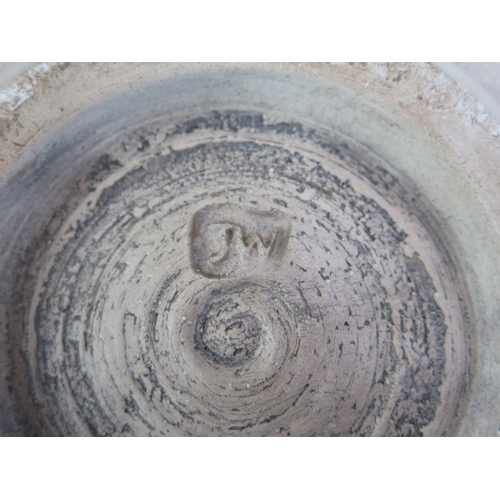 1013 - A large studio pottery bowl of flared circular form, with raised roundel and banded reeded decoratio... 