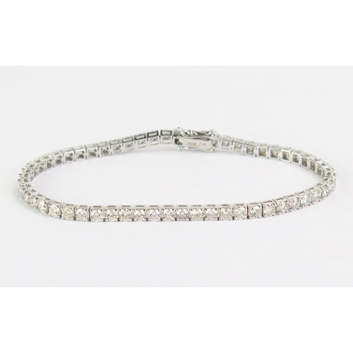 102 - An 18ct White Gold and Diamond Tennis or Line Bracelet, stamped 18K, 5.11ct of diamonds, 7