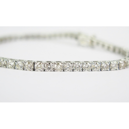 102 - An 18ct White Gold and Diamond Tennis or Line Bracelet, stamped 18K, 5.11ct of diamonds, 7