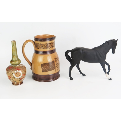 1022 - A Royal Doulton model of a black stallion, a Doulton Lambeth ware cordial jug 