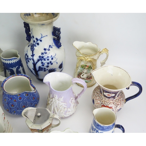 1026 - A collection of late Victorian and later pottery jugs, including moulded jugs, transfer print decora... 