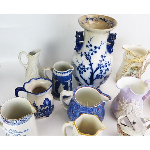 1026 - A collection of late Victorian and later pottery jugs, including moulded jugs, transfer print decora... 