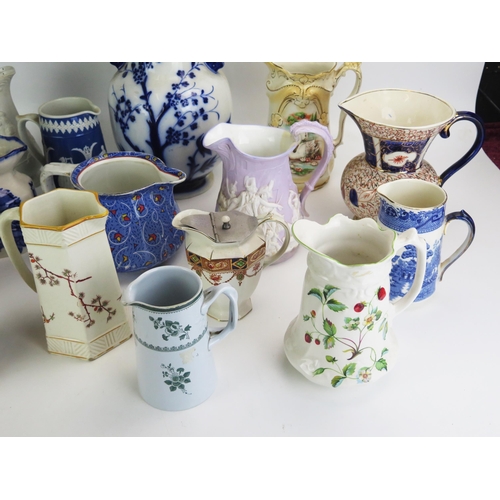 1026 - A collection of late Victorian and later pottery jugs, including moulded jugs, transfer print decora... 