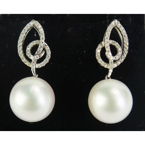 103 - A Pair of 18ct White Gold and untested Pearl Earrings, 30mm drop, 9.14g gross