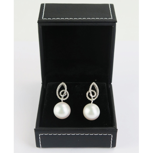 103 - A Pair of 18ct White Gold and untested Pearl Earrings, 30mm drop, 9.14g gross