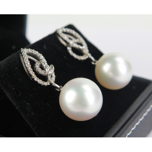 103 - A Pair of 18ct White Gold and untested Pearl Earrings, 30mm drop, 9.14g gross