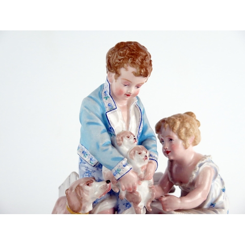 1044 - A Paul Duboy porcelain spill vase, decorated with a standing boy and seated girl playing with puppie... 