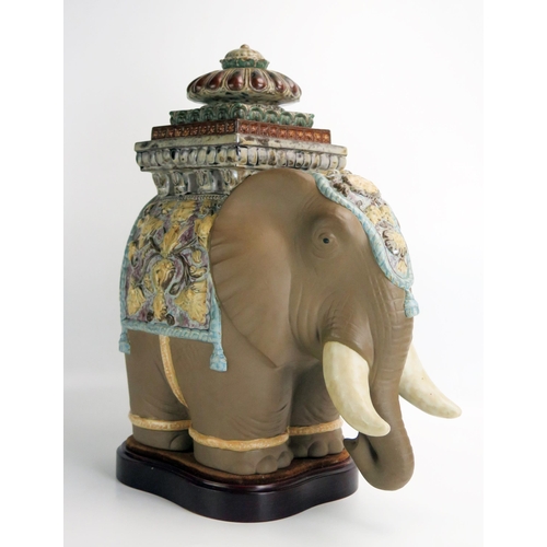 1095 - A Lladro porcelain model of a Siamese elephant, on polished wood base, overall height 43cm high.