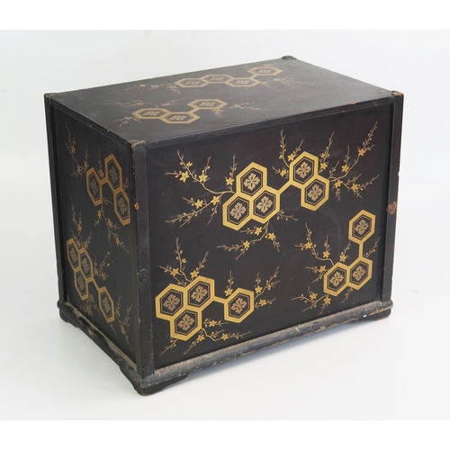 1108 - A Japanese lacquered Tansu, decorated all over with flowerheads and foliage, containing three long g... 