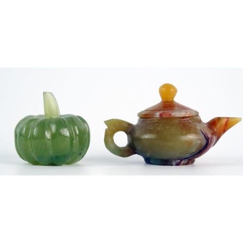 1121 - A polished jadeite miniature teapot and cover, 8cm long, together with a model of a pumpkin.