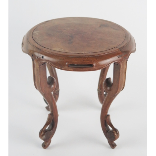 1122 - A Chinese polished hardwood stand of circular outline raised on four swept and pierced legs, 17cm di... 