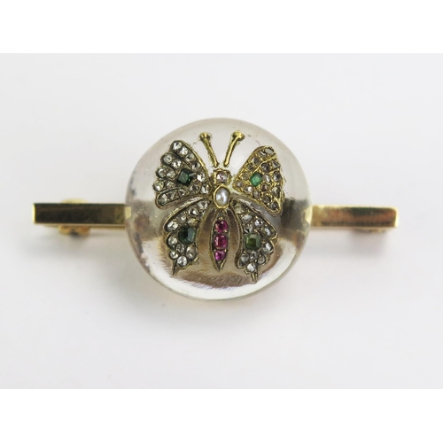 113 - A Crystal Diamond Set Butterfly Brooch with emeralds, rubies and untested pearl on 9ct gold hallmark... 