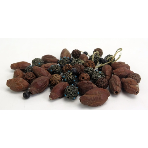 1130 - A collection of loose Chinese carved wood beads, together with white metal beads.