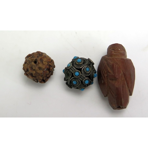 1130 - A collection of loose Chinese carved wood beads, together with white metal beads.