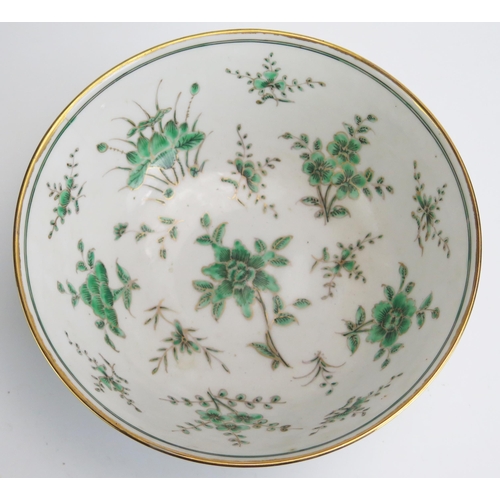 1143 - A Chinese porcelain bowl, with green floral decoration heightened in gilt, bears four character mark... 