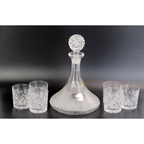 1157 - A crystal glass ships decanter and stopper, with hobnail decoration, with silver brandy label and si... 