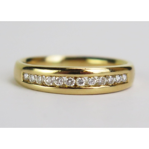 118 - An 18ct Gold and 12 Diamond Twelve Stone Channel Set Ring, hallmarked, size O.75, 4.69g