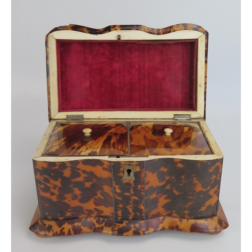 1206 - A 19th century blonde tortoiseshell  tea caddy, of serpentine outline, the domed hinged lid enclosin... 