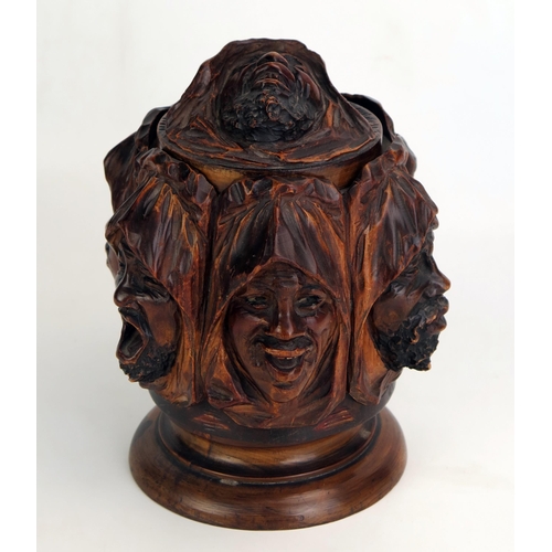 1207 - A carved treen tobacco humidor, decorated with shrouded Arabic faces depicting the seven deadly sins... 