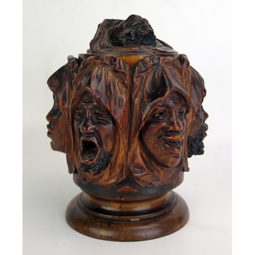 1207 - A carved treen tobacco humidor, decorated with shrouded Arabic faces depicting the seven deadly sins... 