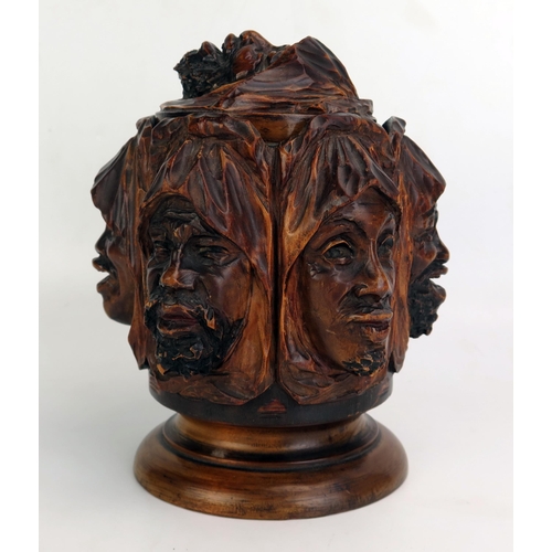 1207 - A carved treen tobacco humidor, decorated with shrouded Arabic faces depicting the seven deadly sins... 