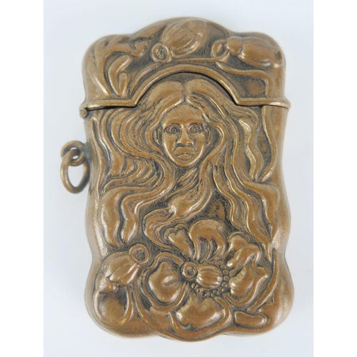 1232 - A reproduction pressed brass vesta case, of Art Nouveau influence, 6.5cm long.