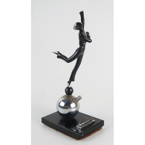 1237 - An Art Deco period figural table lighter, modelled as a dancing girl on a ball, mounted on a polishe... 