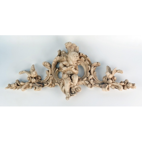 1252 - A composition pediment in the Italianate style, centred with a putti playing a flute, flanked by lov... 