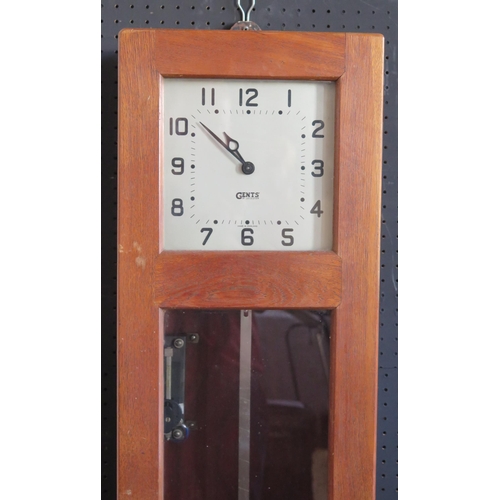 1282 - A GENTS master clock contained in an oak case, with pendulum, 127cm high