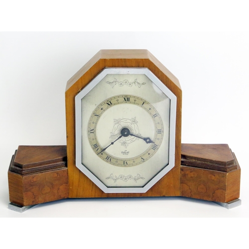 1286 - An Art Deco period walnut mantel timepiece, of arched outline with silvered Roman dial, mounted on c... 