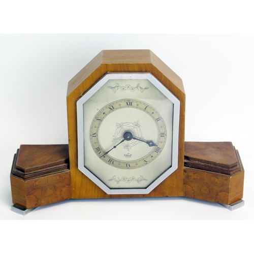 1286 - An Art Deco period walnut mantel timepiece, of arched outline with silvered Roman dial, mounted on c... 