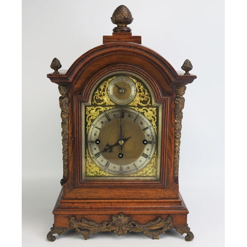 1287 - A late Victorian/Edwardian oak mantel clock, of arched outline, with brass arched dial, silvered cha... 