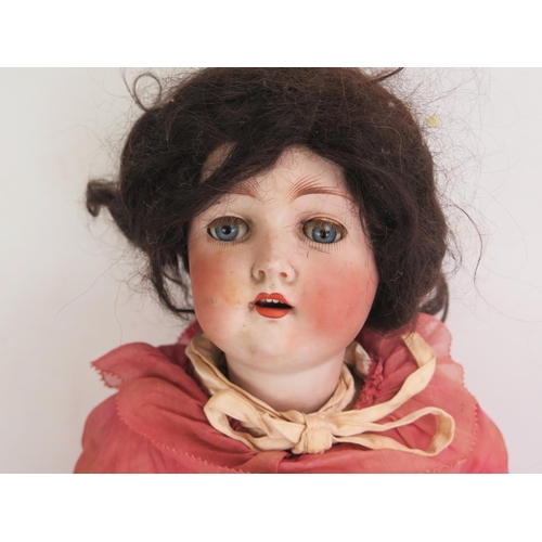 1336 - A German Bisque Headed Doll inscribed 136/8 with blue glass opening eyes with 4 teeth, brown wig, pi... 