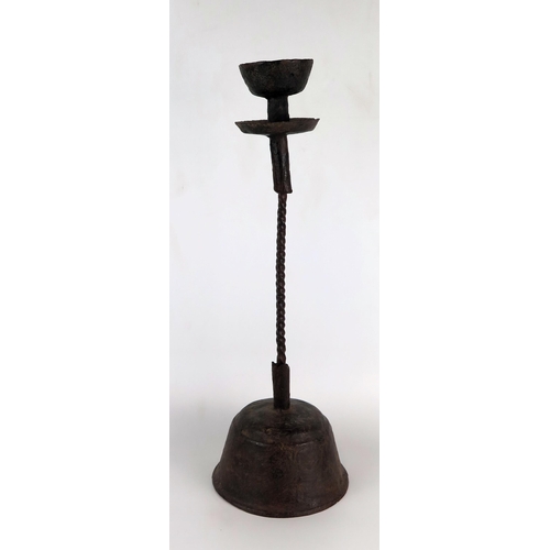 1347 - A late 16th/early 17th century wrought iron candle stand, with spiral twist stems on a domed circula... 