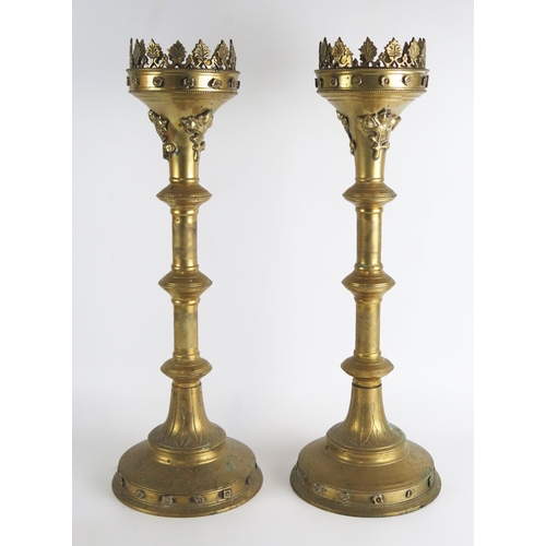 1349 - A pair of brass pricket candlesticks in the Italianate style, with flared and foliate decorated rims... 