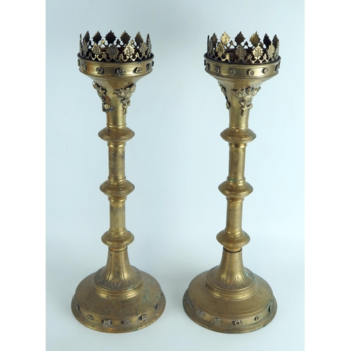 1349 - A pair of brass pricket candlesticks in the Italianate style, with flared and foliate decorated rims... 