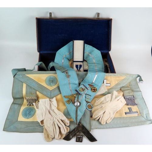 1351 - Two Masonic aprons, sash and assorted jewels contained in a leather case.